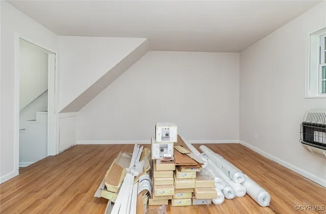 a view of a bedroom with wooden floor