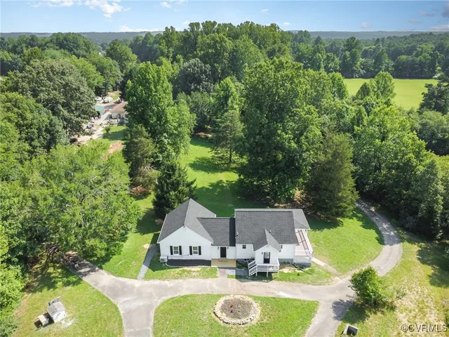 an aerial view of a house with yard swimming pool and outdoor seating