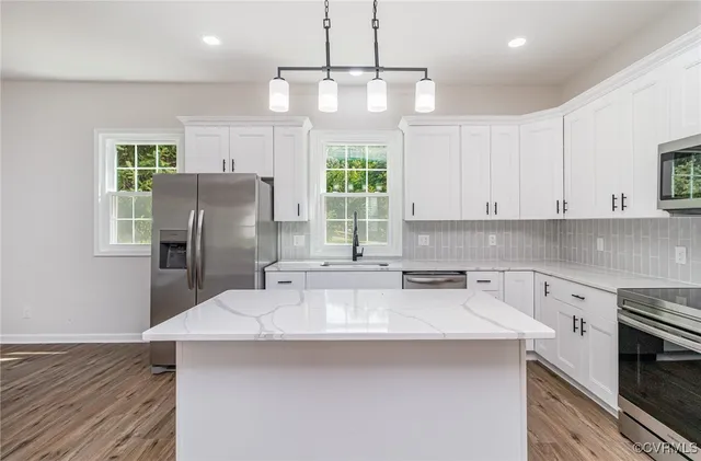 a kitchen with refrigerator cabinets and wooden floor