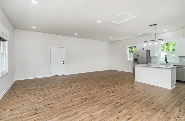 a view of kitchen and empty room