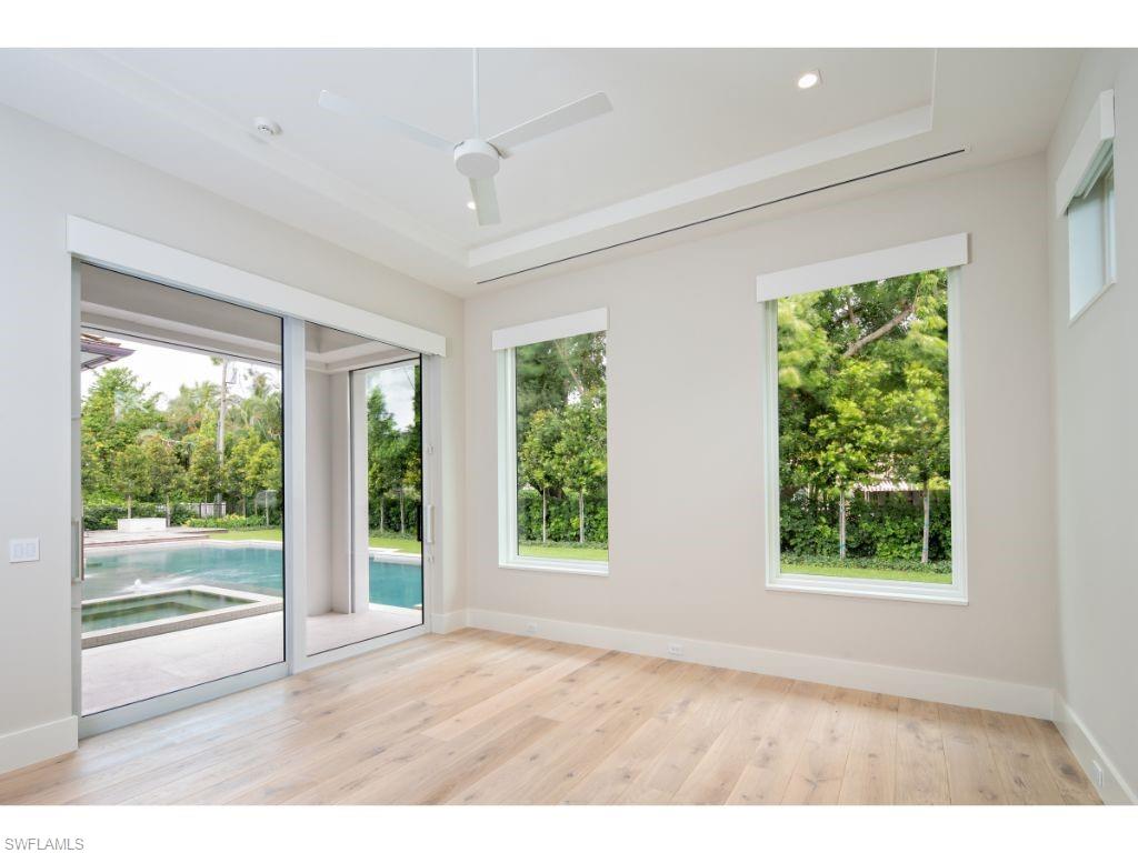1325 Murex Drive Naples, FL 34102 - Photo 13 of 18 an empty room with wooden floor and windows
