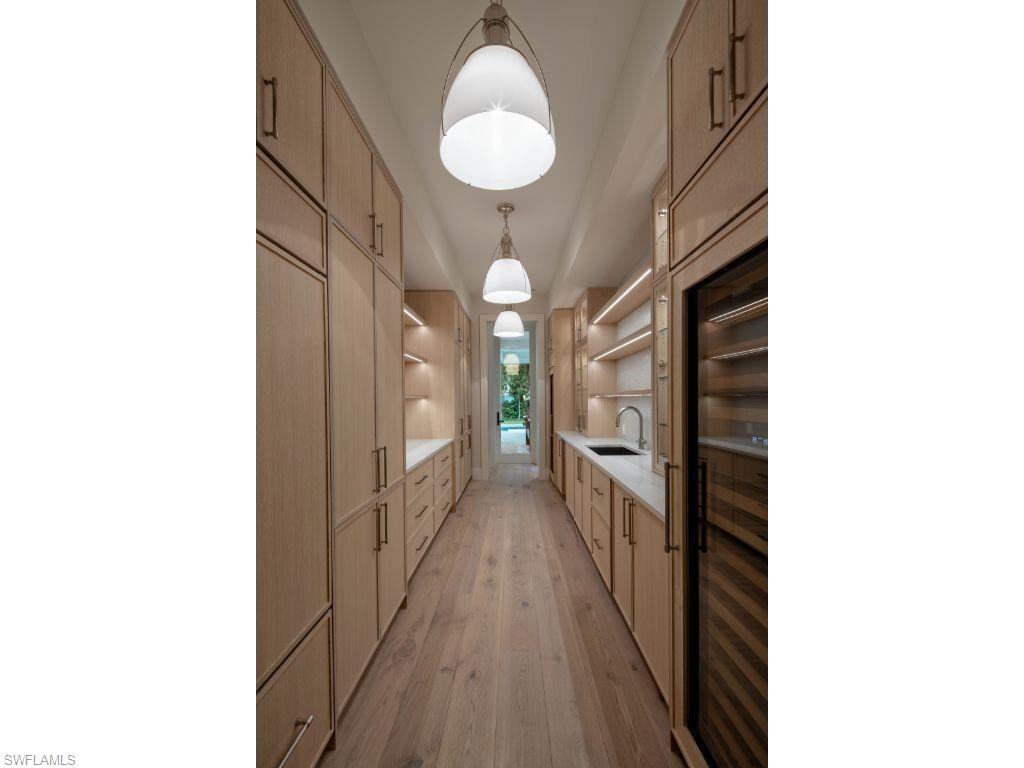 1325 Murex Drive Naples, FL 34102 - Photo 14 of 18 a view of a hallway with wooden floor and staircase