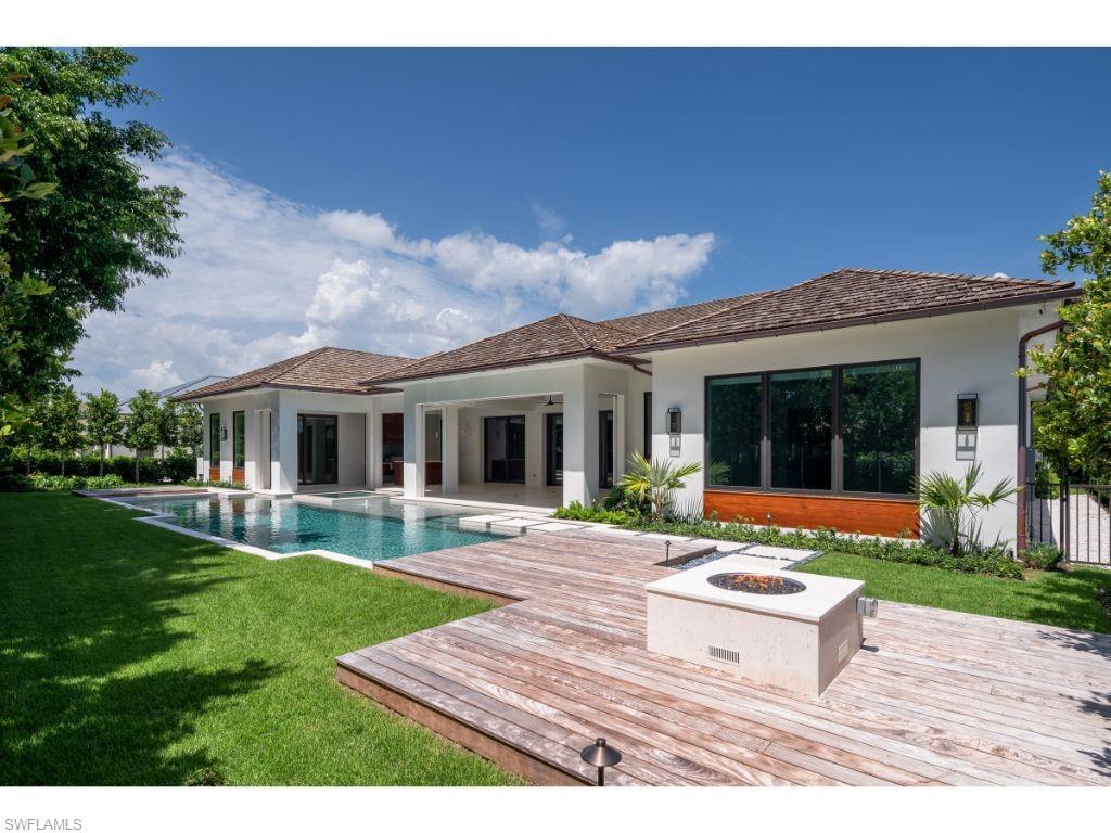 1325 Murex Drive Naples, FL 34102 - Photo 15 of 18 a front view of house with a garden and patio
