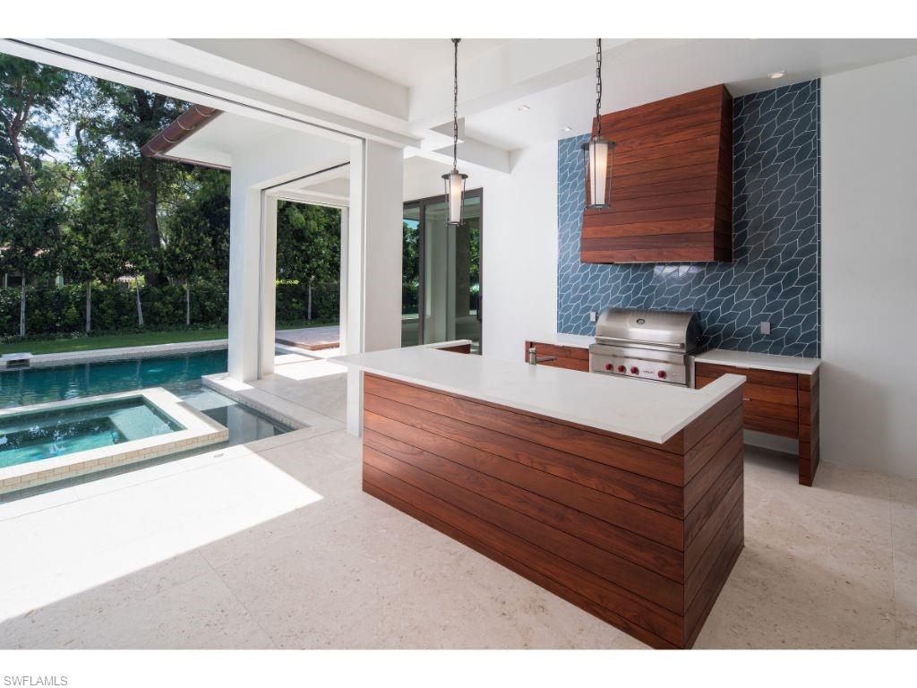 1325 Murex Drive Naples, FL 34102 - Photo 17 of 18 a living room with couch cabinet and a floor to ceiling window