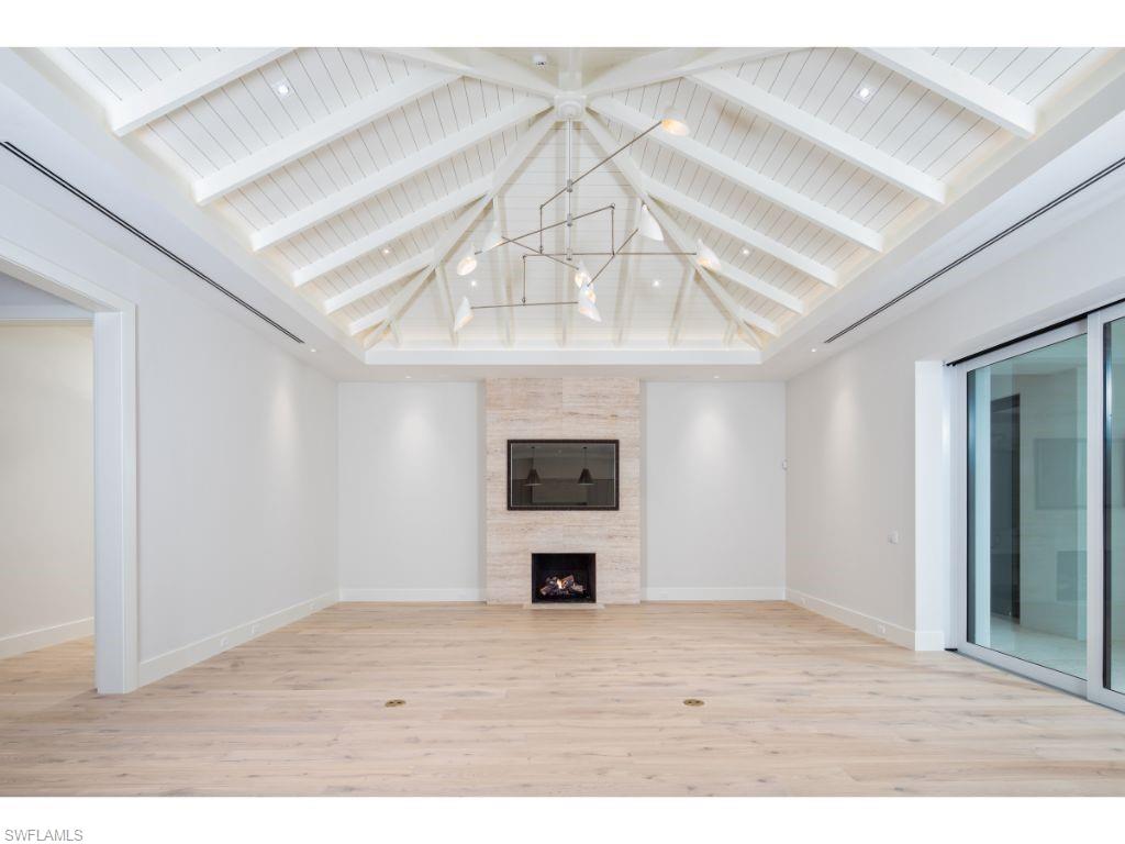 1325 Murex Drive Naples, FL 34102 - Photo 7 of 18 a view of an empty room with a window and a fireplace