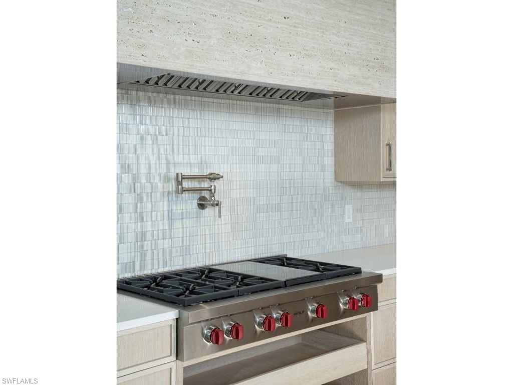 1325 Murex Drive Naples, FL 34102 - Photo 10 of 18 a stove top oven sitting inside of a kitchen