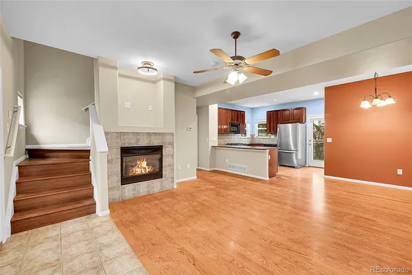 a view of an empty room with a fireplace and a window