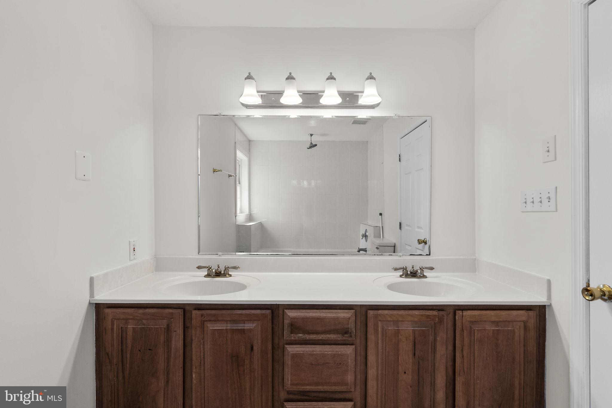 24000 Clarksburg Road Clarksburg, MD 20871 - Photo 40 of 60 a bathroom with a sink and a mirror