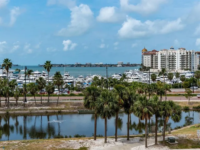 a living room with furniture kitchen view and a window