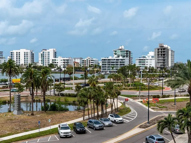 a dining room with furniture and a floor to ceiling window