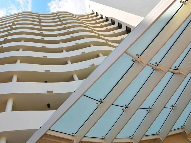 a view of a patio with a table and chairs under an umbrella
