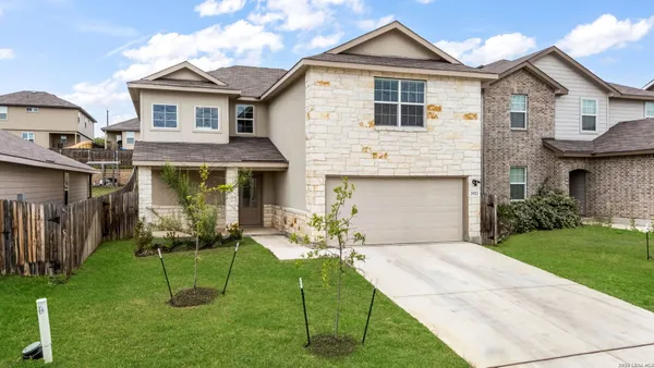 a front view of house with yard and outdoor seating