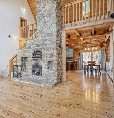 a view of a dining room with furniture a chandelier and kitchen view