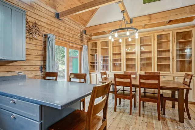 a kitchen with a sink and large windows