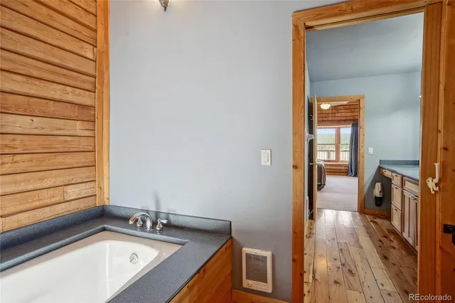 a bathroom with a granite countertop shower sink and mirror