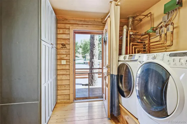 a spacious bedroom with a large bed and a chandelier