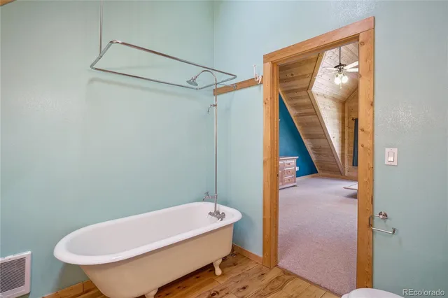 a bathroom with a granite countertop sink toilet and mirror