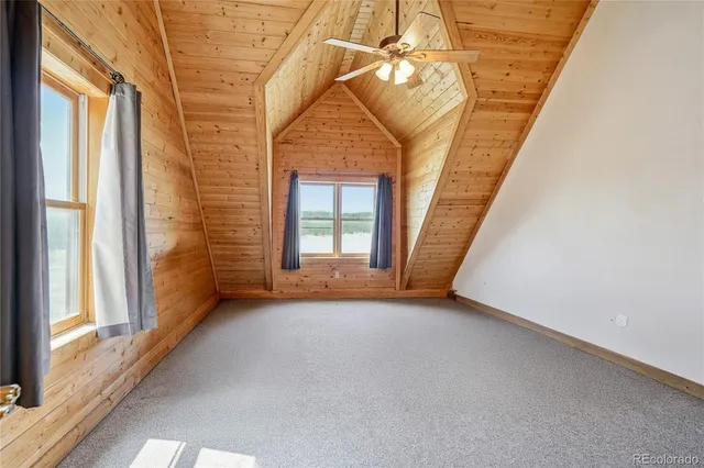 a backyard of a house with barbeque oven table and chairs