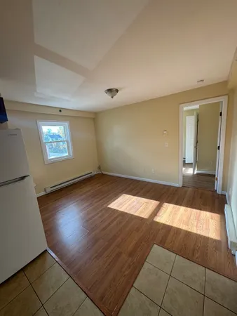 a view of wooden floor and windows in a room