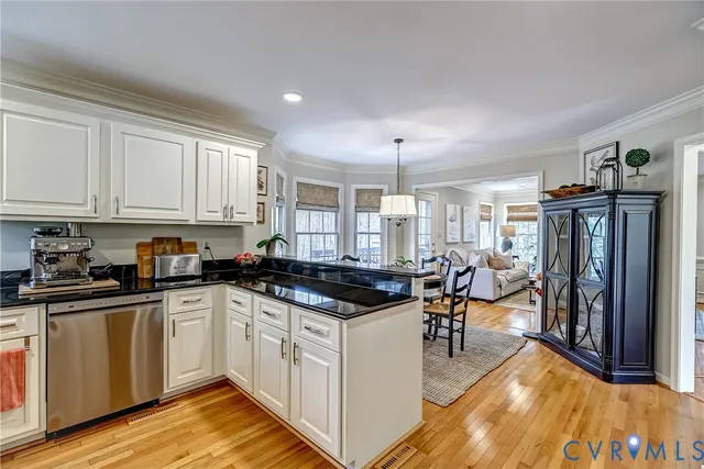 a kitchen with a stove and white cabinets