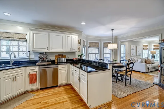 a kitchen with granite countertop a stove top oven and cabinets