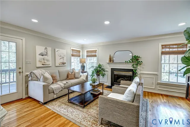 a living room with furniture potted plant and windows
