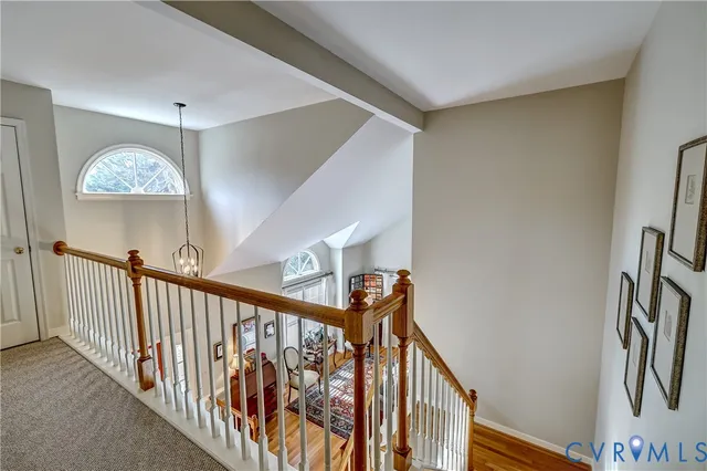 a spacious bedroom with a bed chandelier and a window