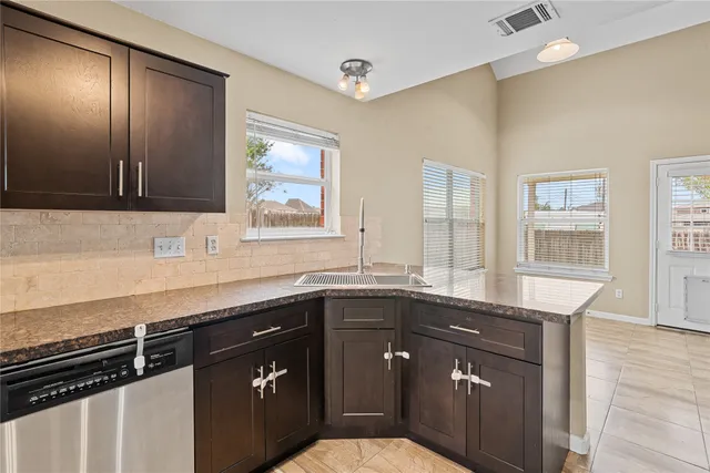 a kitchen with a sink and a refrigerator