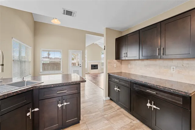 a kitchen with a sink stove and cabinets