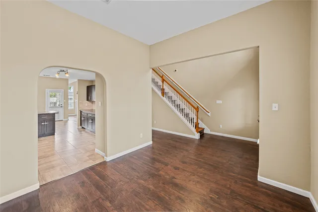 a view of a hallway view with wooden floor and staircase