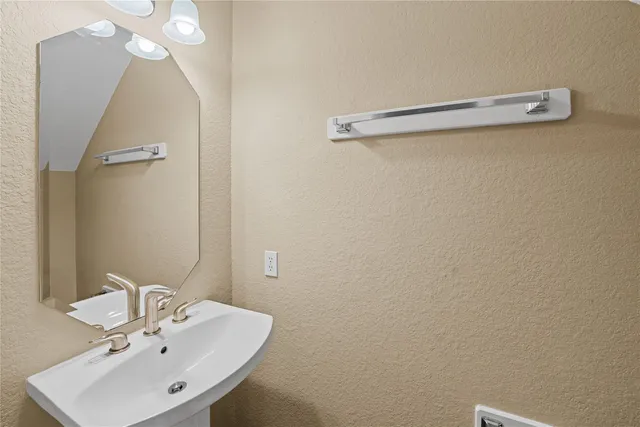 a bathroom with a sink a mirror and a toilet