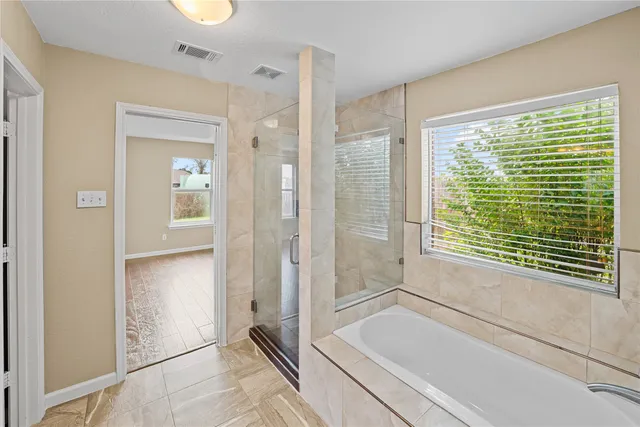 a bathroom with a bathtub and a shower