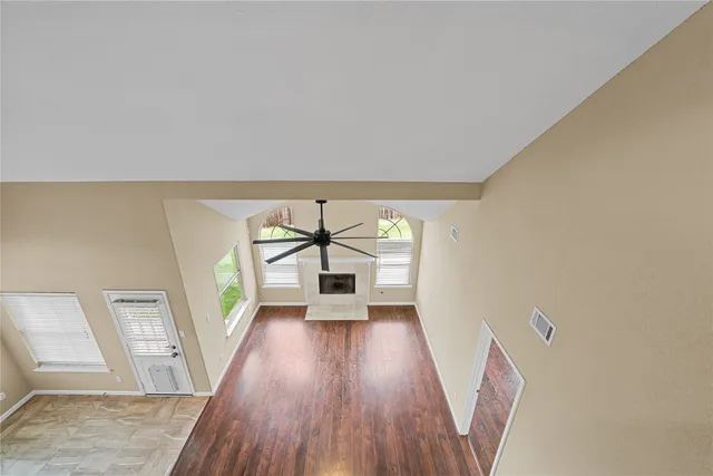 wooden floor in an empty room with a window