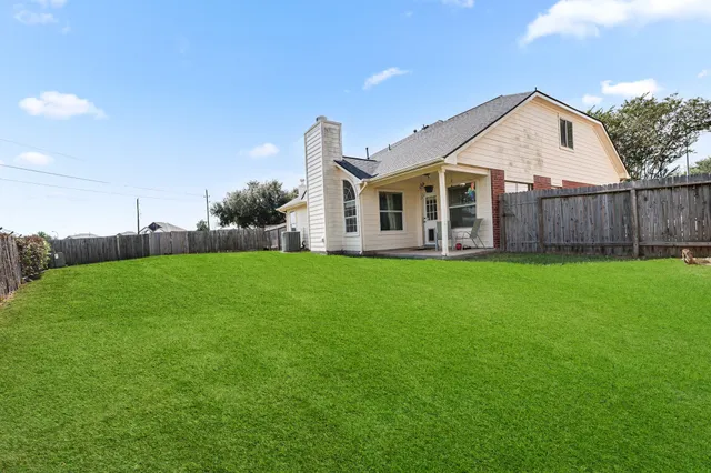 a view of a house with a yard and sitting area