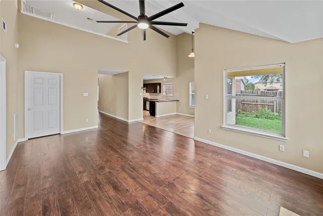 wooden floor in an empty room with a window