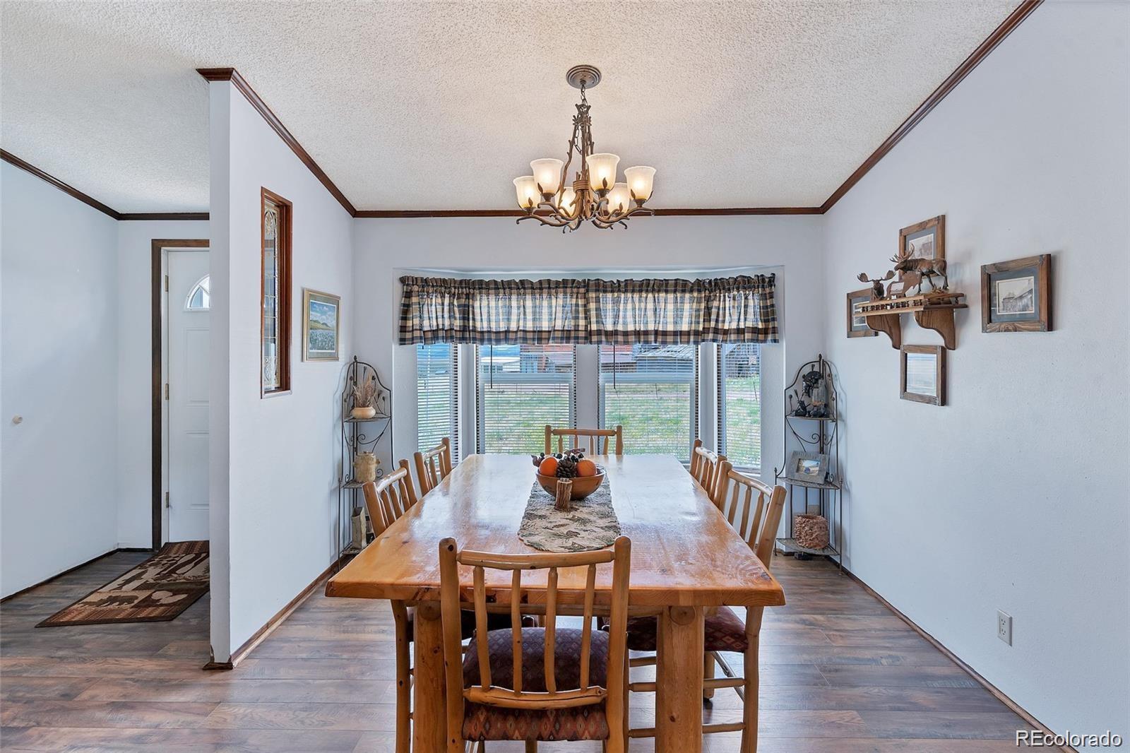 75 6th Street Como, CO 80432 - Photo 12 of 33 a view of a dining room with furniture window and wooden floor