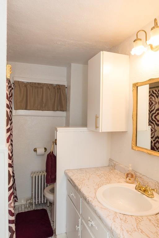 134 Draper Street Springfield, MA 01108 - Photo 19 of 23 a bathroom with a granite countertop sink and a mirror