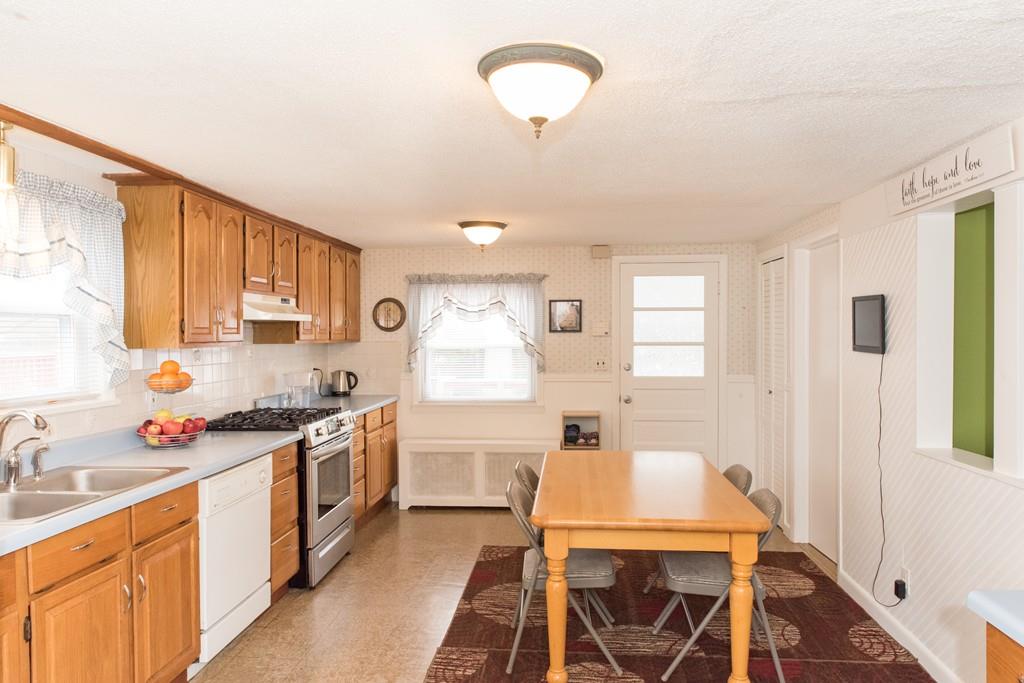 134 Draper Street Springfield, MA 01108 - Photo 7 of 23 a kitchen with a stove a sink and a refrigerator