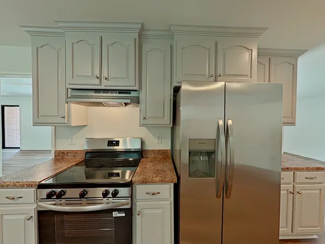 a view of a room with wooden floor and windows