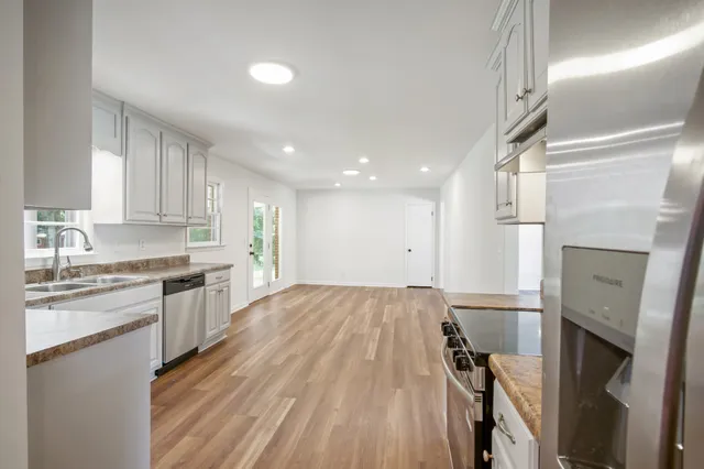 a view of empty room with wooden floor