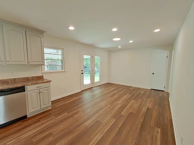 wooden floor in an empty room with a window