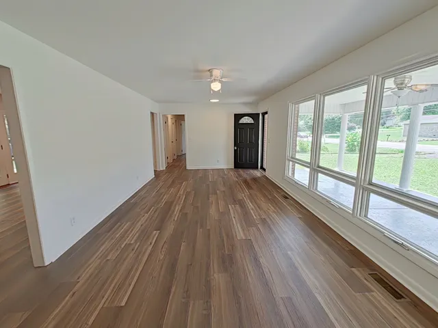 a kitchen with white cabinets and sink