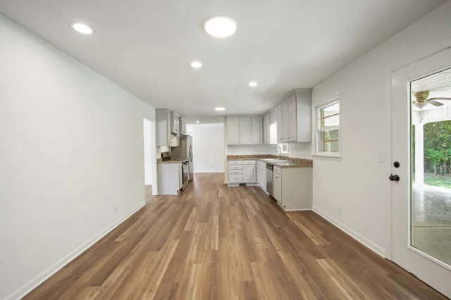 a view of an empty room with wooden floor