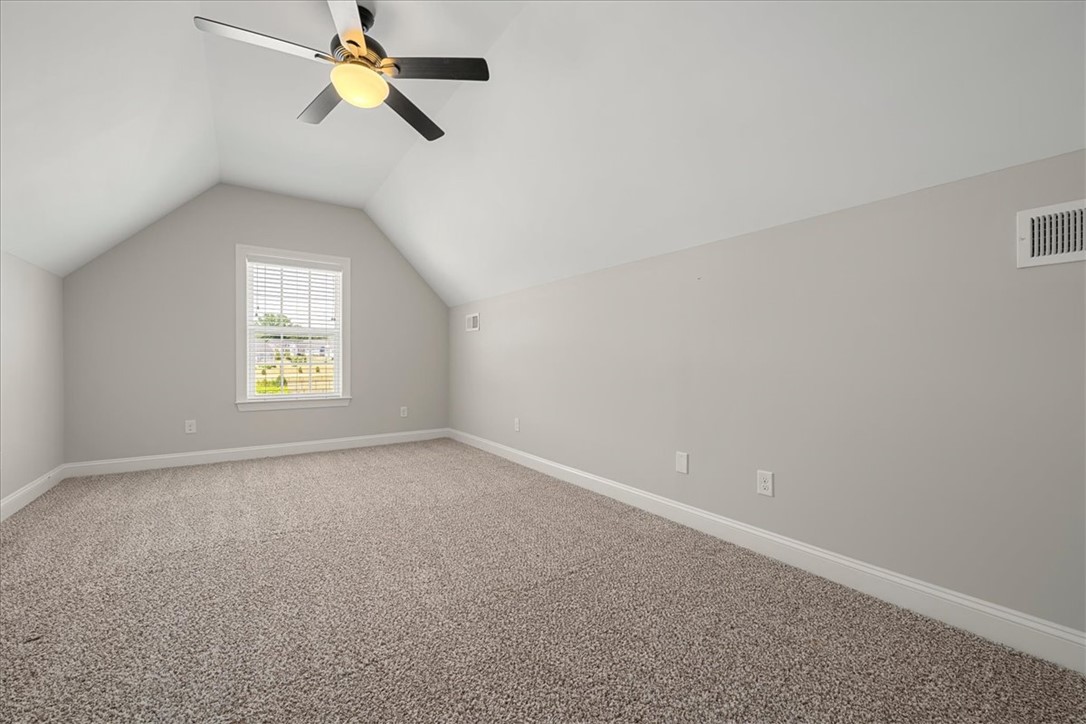 21 Barron Glenn Way Anderson, SC 29621 - Photo 34 of 48 A Desirable Bonus room Upstairs, features a vaulted ceiling, a single window, and plush carpeting.