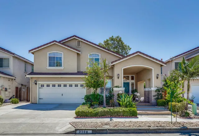 a front view of a house with garden