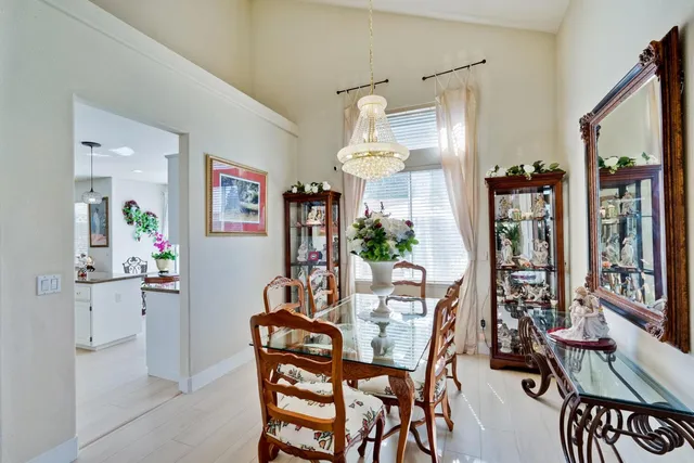 a kitchen with stainless steel appliances granite countertop sink stove and white cabinets with wooden floor