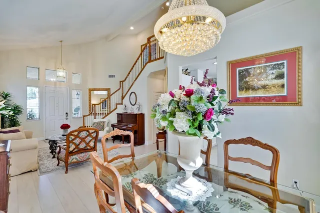 a kitchen that has a lot of cabinets appliances and a dining table