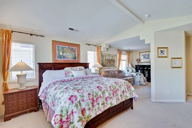 a spacious bathroom with a tub sink and mirror