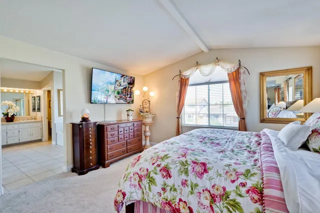 a spacious bedroom with a bed and a window