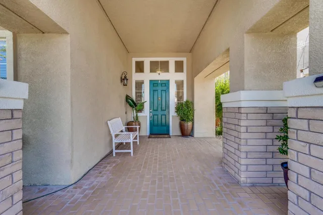 a view of a patio with table and chairs and wooden floor